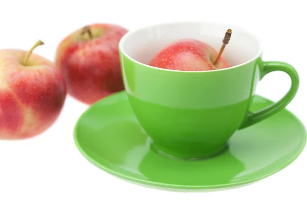 Cup, saucer and apples isolated on white — Stock Photo, Image