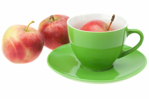 Cup, saucer and apples isolated on white — Stock Photo, Image