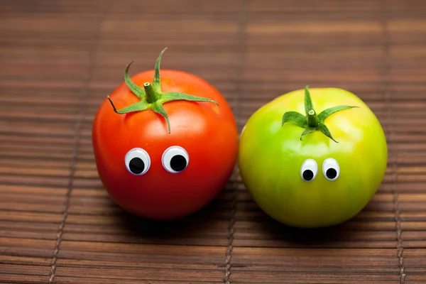 Tomato with eyes on a bamboo mat — Stock Photo, Image