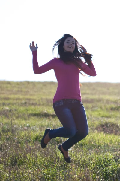Beautiful teenager woman jumping outdoors — Stock Photo, Image