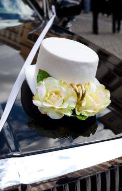 Wedding decoration in the form of hats on the hood of car clipart