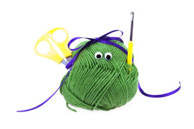 Skein of wool with eyes, ribbon, scissors and crochet hooks isol clipart