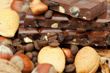 Bar of chocolate and nuts on a wicker mat