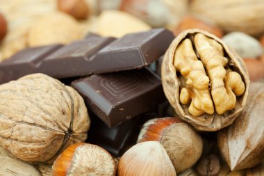 Bar of chocolate and nuts on a wicker mat