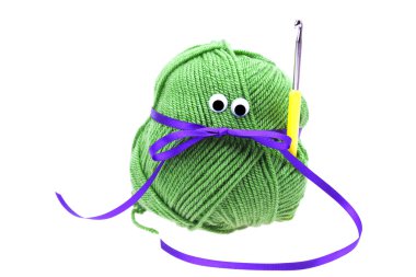 Skein of wool with eyes, ribbon and crochet hooks isolated on w clipart