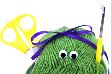 Skein of wool with eyes, ribbon, scissors and crochet hooks isol clipart