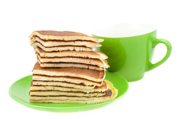 Pancakes on a plate and cup isolated on white — Stock Photo, Image