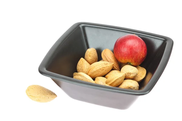 Almonds in a bowl and apples isolated on white — Stock Photo, Image