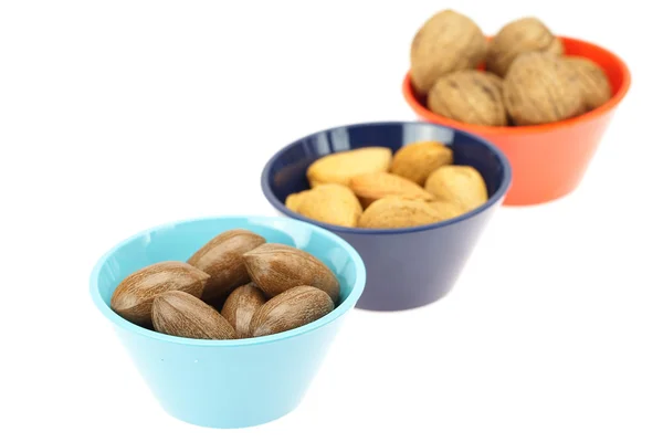 Nuts in bowls isolated on white — Stockfoto