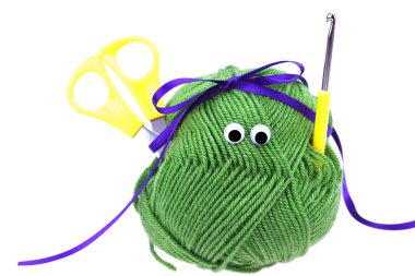 Skein of wool with eyes, ribbon, scissors and crochet hooks isol clipart