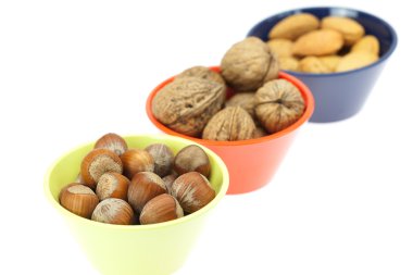 Nuts in bowls isolated on white