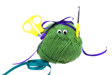 Skein of wool with eyes, ribbon, scissors and crochet hooks isol clipart