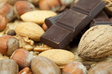 Bar of chocolate and nuts on a wicker mat