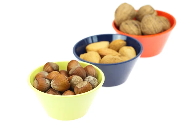 Nuts in bowls isolated on white — Stok fotoğraf