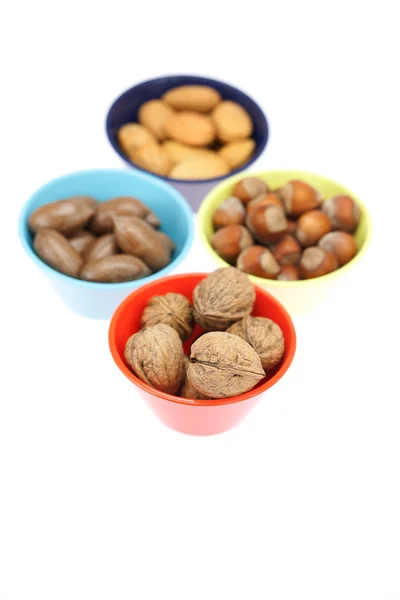 Nuts in bowls isolated on white — Stock Photo, Image