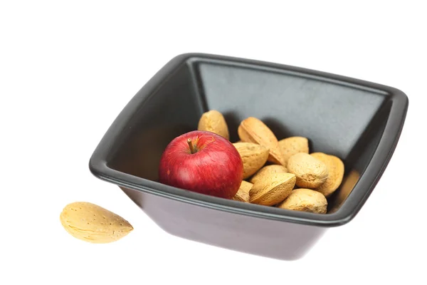 Almonds in a bowl and apples isolated on white — Stock Photo, Image