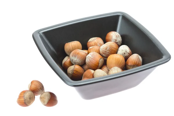 Hazelnuts in a bowl isolated on white — Stock Photo, Image