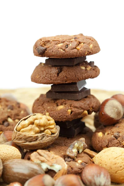 Oatmeal cookies, chocolate and nuts on a wicker mat — Stock Photo, Image