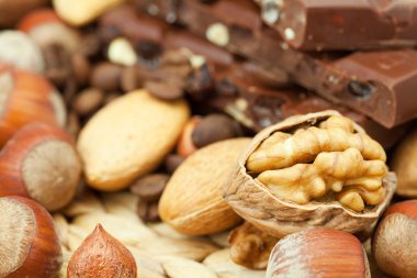 Bar of chocolate and nuts on a wicker mat