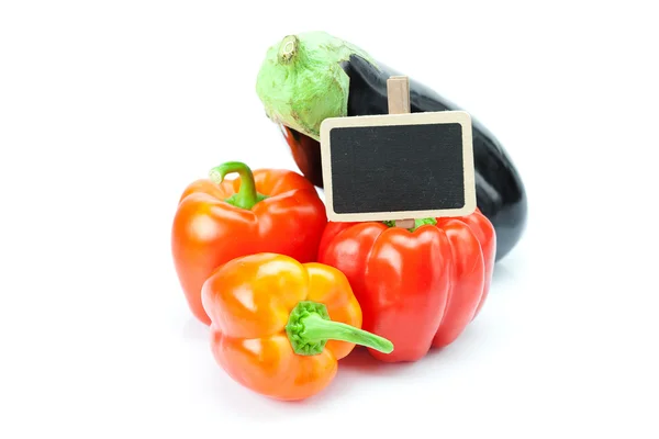stock image Red peppers, eggplant and board isolated on white