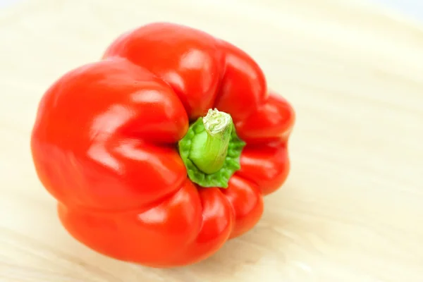 Red pepper on a cutting board isolated on white — Stock Photo, Image