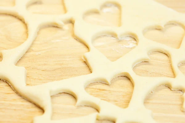 Cut in the dough snowman, heart, and house — Stock Photo, Image