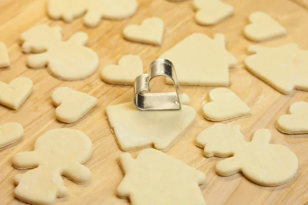 Cut dough snowman, house, heart, and forms for cookies — Stock Photo, Image