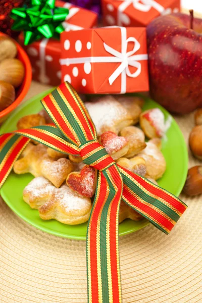 stock image Dish, cookies, nuts, apple, bows, boxes, gifts, Christmas balls