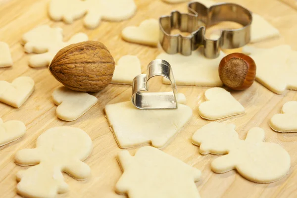 Cut dough snowman, house, nuts, heart and forms for the cookies — Stock Photo, Image