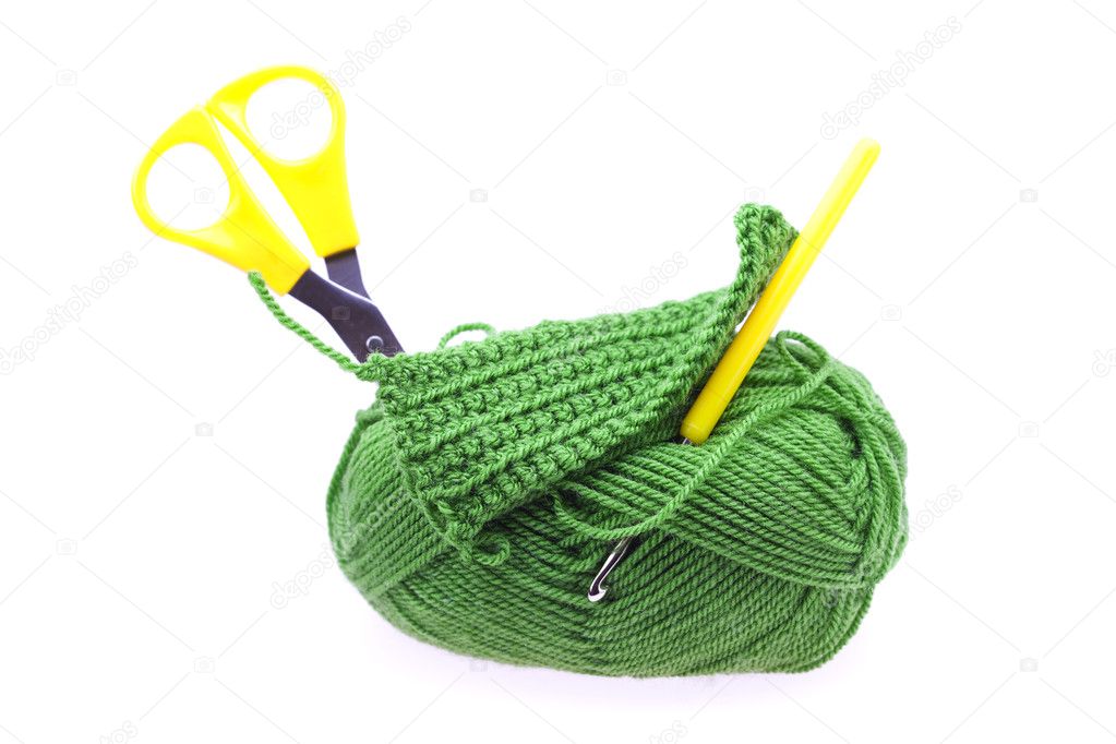 Skein of wool with scissors and crochet hooks isolated on white