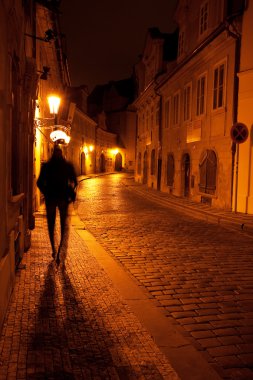 A beautiful night view of the street and the shadow of a man in clipart
