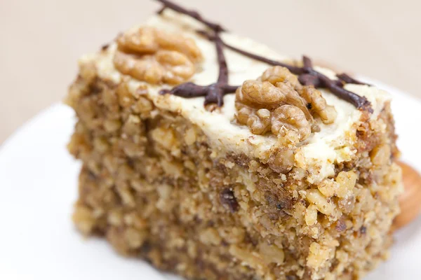 Pedazo de pastel con nueces acostadas en el plato —  Fotos de Stock