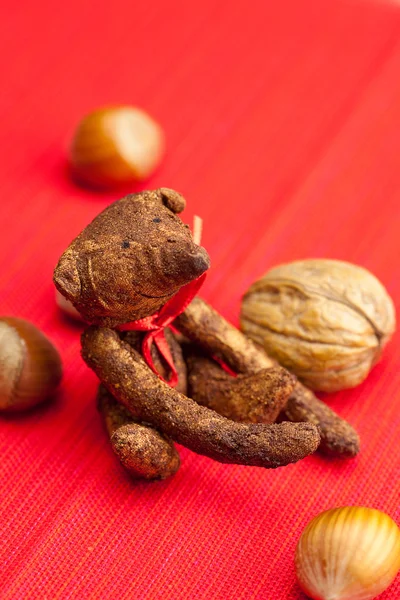 Teddy bear handmade and nuts on a red background — Stock Photo, Image