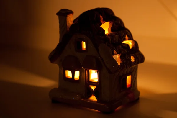 A decorative house with a candle inside — Stock Photo, Image
