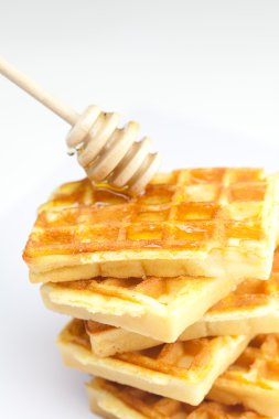 lezzetli Belçika waffle ve sopa üzerinde beyaz izole Bala