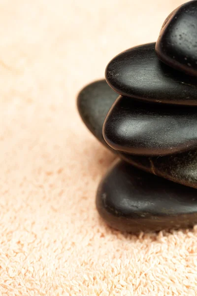 A black spa stones on the towel — Stock Photo, Image