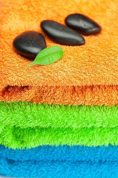 Fondo de las tres toallas de rizo multicolor y spa negro —  Fotos de Stock