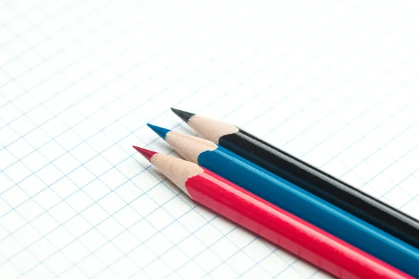 Plaid notebook with a spiral and colored pencil — Stock Photo, Image