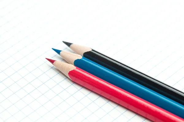 Plaid notebook with a spiral and colored pencil — Stock Photo, Image