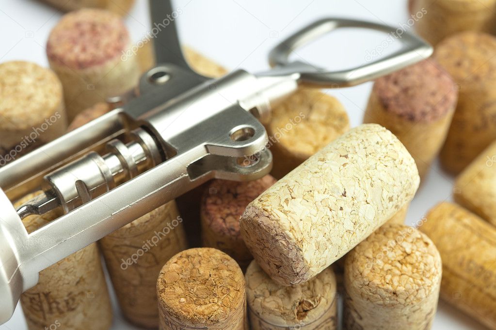 Background of the mountains of wine corks and a corkscrew