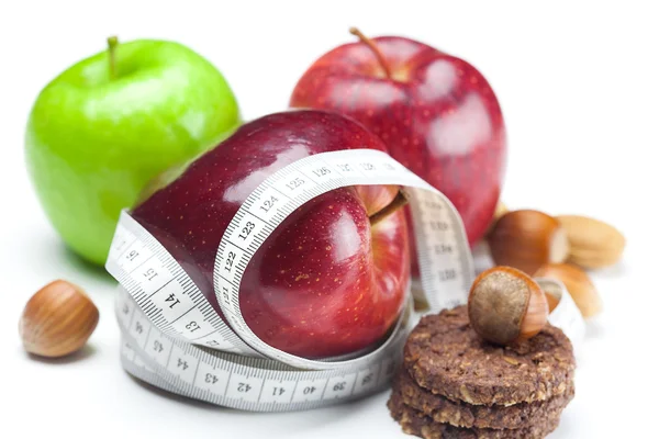 Appel, noten, cookies en maatregel tape geïsoleerd op wit — Stockfoto