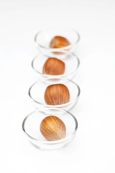 Nuts in miniature glass bowls isolated on white — Stock Photo, Image