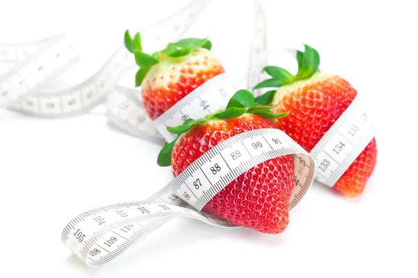 Big juicy red ripe strawberries,nuts and measure tape isolated o — Stock Photo, Image