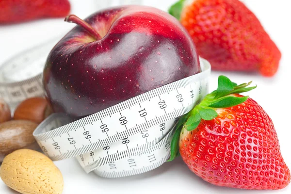 Big juicy red ripe strawberries,apple,nuts and measure tape isol — Stock Photo, Image