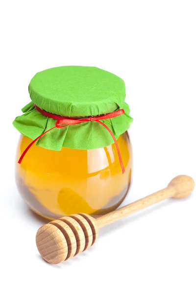 Se adhieren a hohey y tarro de miel aislado en blanco — Foto de Stock