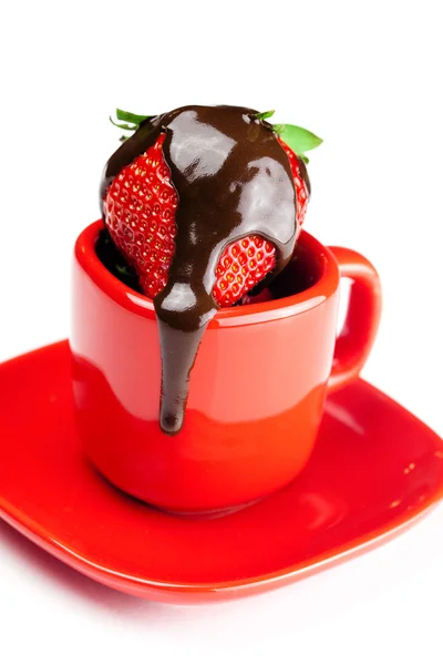 Strawberries in chocolate lying in a red cup isolated on white — Stock Photo, Image