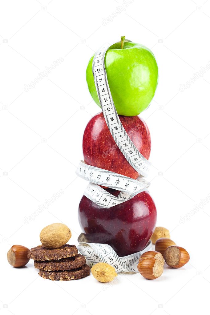 Apple, nuts, cookies and measure tape isolated on white