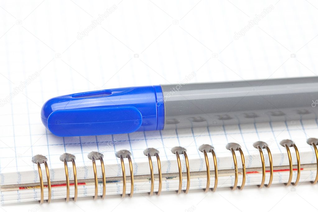 Colored markers and a notebook isolated on white