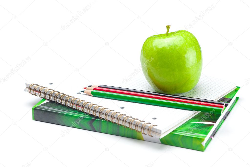 Apple, notebooks and pencils isolated on white
