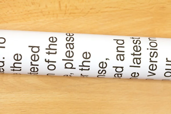 Paper rolled into a tube on the floor — Stock Photo, Image